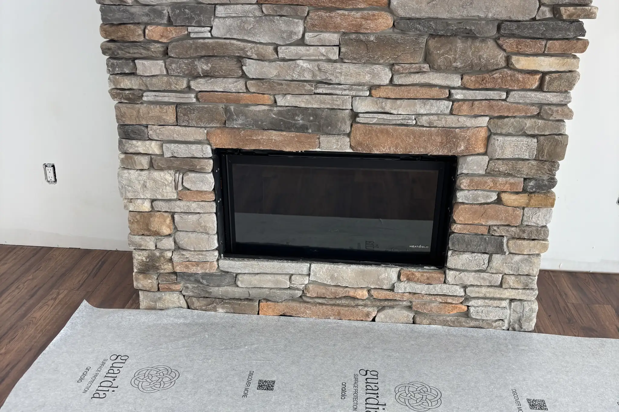 Finished stone fireplace hooked up to the gas