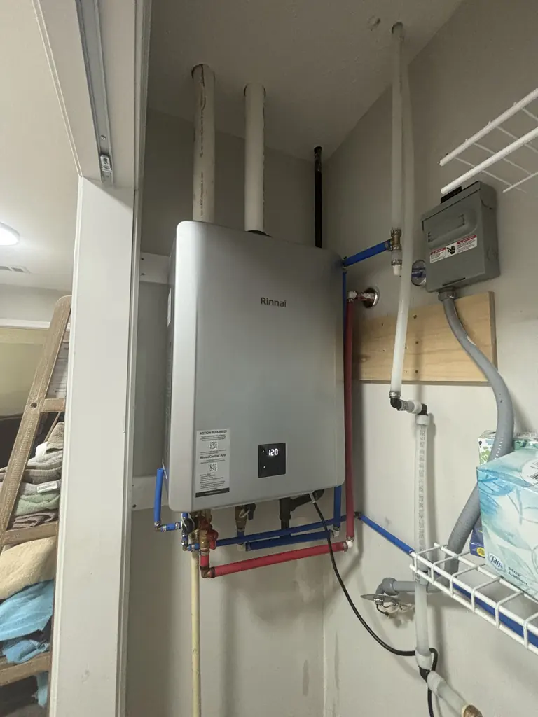 Tankless water heater installed in a laundry room